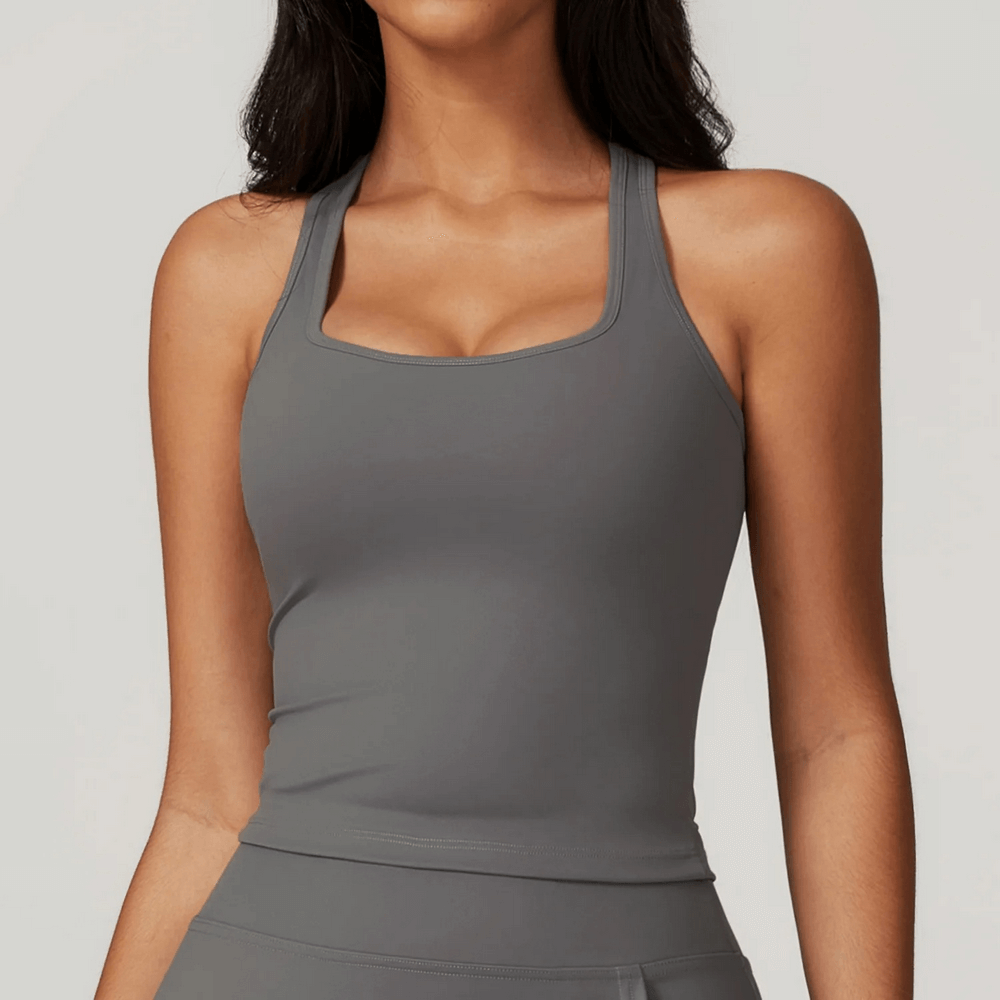Elastic quick-dry fitness tank top for women, sleeveless and breathable, perfect for running and workouts. Stylish and flexible design.